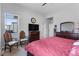 Main bedroom with ceiling fan, large windows, comfortable furniture, and wood dresser at 5110 E 64Th Ave, Commerce City, CO 80022