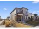 Contemporary two-story home with gray siding, well-manicured lawn, and inviting front porch at 5110 E 64Th Ave, Commerce City, CO 80022