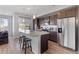 Modern kitchen boasts stainless steel appliances, granite countertops, and wood cabinets at 5110 E 64Th Ave, Commerce City, CO 80022