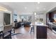 Open-concept living room and kitchen area with modern finishes and abundant natural light at 5110 E 64Th Ave, Commerce City, CO 80022