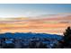 Aerial view of a residential neighborhood with snow-capped mountains in the background at 3851 Stonebrush Dr # 11B, Littleton, CO 80126