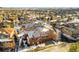 Aerial view of a townhouse community with snow-covered homes and roads at 3851 Stonebrush Dr # 11B, Littleton, CO 80126
