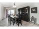 Dining area with dark wood table and chairs near a sliding glass door at 3851 Stonebrush Dr # 11B, Littleton, CO 80126