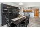 Open concept dining room with dark wood table and chairs, and built-in hutch at 3851 Stonebrush Dr # 11B, Littleton, CO 80126