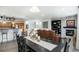 Open concept dining room with dark wood table and chairs, and views of the living room and kitchen at 3851 Stonebrush Dr # 11B, Littleton, CO 80126