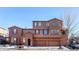 Three-story stucco home with three-car garage at 3851 Stonebrush Dr # 11B, Littleton, CO 80126