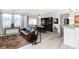 Living room with a brown leather reclining sofa and view into dining area and kitchen at 3851 Stonebrush Dr # 11B, Littleton, CO 80126