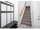 Staircase with wood handrail and neutral carpet at 3851 Stonebrush Dr # 11B, Littleton, CO 80126
