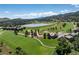 Aerial view of a lake, a golf course, neighborhood homes and scenic mountain views at 16223 River Haven Way, Morrison, CO 80465