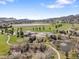 Breathtaking aerial view of a community with a golf course and lakes, highlighting the serene surroundings at 16223 River Haven Way, Morrison, CO 80465