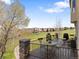 Spacious wood deck with metal railings, a table with four chairs, and a view of the golf course and mountains at 16223 River Haven Way, Morrison, CO 80465