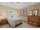 Charming bedroom with a plush bed, bedside tables, a dresser and a large window at 16223 River Haven Way, Morrison, CO 80465