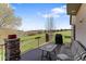 Outdoor deck overlooking a golf course featuring a grill, striped seating and stone decor at 16223 River Haven Way, Morrison, CO 80465