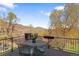 Outdoor deck offering a seating area with a table and chairs, a stone pillar and scenic views at 16223 River Haven Way, Morrison, CO 80465