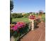 Deck featuring flower decor, a beautiful golf course view and elegant homes in the background at 16223 River Haven Way, Morrison, CO 80465