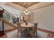 Inviting dining room with a round table, staircase access, and elegant lighting at 16223 River Haven Way, Morrison, CO 80465