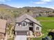 Charming home with a stone facade, tile roof, and a beautifully landscaped front yard and golf course views at 16223 River Haven Way, Morrison, CO 80465