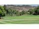 A meticulously maintained golf course fairway with scenic views of the surrounding mountains at 16223 River Haven Way, Morrison, CO 80465