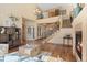 Spacious living room featuring hardwood floors, a fireplace, and an open floor plan with staircase at 16223 River Haven Way, Morrison, CO 80465