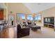 Bright living room boasting large windows with scenic views, a cozy seating area, and hardwood floors at 16223 River Haven Way, Morrison, CO 80465