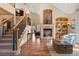 Living room with cozy fireplace, built-in shelves, and staircase leading to the upper level at 16223 River Haven Way, Morrison, CO 80465