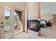 Bright main bedroom featuring a fireplace, a private balcony and scenic golf course and mountain views at 16223 River Haven Way, Morrison, CO 80465