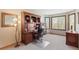 Home office with built-in shelving, a large desk, and a window providing natural light and serene views for a productive workspace at 16223 River Haven Way, Morrison, CO 80465