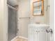 Bathroom showcasing a corner sink vanity with a white cabinet and enclosed glass shower at 17753 E Nassau Pl, Aurora, CO 80013