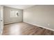 Bedroom with window and light colored walls and hardwood look flooring at 17753 E Nassau Pl, Aurora, CO 80013