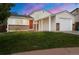 Charming home featuring a brick facade, a red front door, and an attached garage at 17753 E Nassau Pl, Aurora, CO 80013