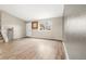 Bright living room featuring light wood floors, neutral walls, and staircase at 17753 E Nassau Pl, Aurora, CO 80013