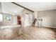 Bright living room featuring light wood floors, neutral walls, and staircase at 17753 E Nassau Pl, Aurora, CO 80013