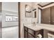Bathroom with a vanity and sink, located adjacent to the bedroom, offers convenience and privacy at 6670 W 84Th Cir # 99, Arvada, CO 80003
