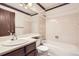 Cozy bathroom featuring a vanity with a sink, toilet, and tiled shower-tub combination at 6670 W 84Th Cir # 99, Arvada, CO 80003