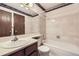 Cozy bathroom featuring a vanity, toilet, and a tiled shower-tub combination at 6670 W 84Th Cir # 99, Arvada, CO 80003
