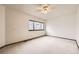 Bright bedroom features a ceiling fan and a large window with neighborhood views, inviting natural light at 6670 W 84Th Cir # 99, Arvada, CO 80003