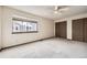 Large bedroom with generous closet space and a sunlit window looking out at neighboring homes at 6670 W 84Th Cir # 99, Arvada, CO 80003