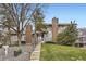 Front exterior of a well-kept townhome with lush green lawn, steps, and mature trees at 6670 W 84Th Cir # 99, Arvada, CO 80003