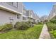Exterior view of townhomes, showcases well-maintained landscaping with grassy areas and a walkway at 6670 W 84Th Cir # 99, Arvada, CO 80003