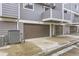Exterior view of gray siding townhomes with brown garage doors and concrete driveway numbered 99, 98, and 97 at 6670 W 84Th Cir # 99, Arvada, CO 80003