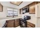 Bright kitchen features a double basin sink, sleek black appliances, and ample countertop space for meal preparation at 6670 W 84Th Cir # 99, Arvada, CO 80003