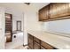 A bright kitchen with wood cabinets is adjacent to the entryway, offering seamless access and a welcoming atmosphere at 6670 W 84Th Cir # 99, Arvada, CO 80003