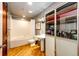 Bright bathroom with a pedestal sink, tub/shower, and a cabinet with glass doors for towels and toiletries at 1863 Wazee St # 4B, Denver, CO 80202