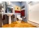 Cozy bathroom with a pedestal sink, a large mirror, and a glass-enclosed shower at 1863 Wazee St # 4B, Denver, CO 80202