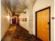 Hallway features exposed pipes, concrete ceiling and modern doors to individual condos at 1863 Wazee St # 4B, Denver, CO 80202