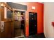 Hallway featuring an old-fashioned elevator with black and gold detailing, a fire alarm, and an exit sign at 1863 Wazee St # 4B, Denver, CO 80202