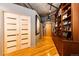 Hallway with closet doors, built-in shelving, hardwood floors, and a concrete ceiling at 1863 Wazee St # 4B, Denver, CO 80202