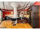 A modern kitchen features dark wood cabinets, a round dining table, and stainless steel appliances at 1863 Wazee St # 4B, Denver, CO 80202