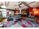Open-concept living room features a partial kitchen view, hardwood floors, and exposed concrete ceilings at 1863 Wazee St # 4B, Denver, CO 80202