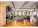 Open-concept living room with hardwood floors, exposed brick, and large windows at 1863 Wazee St # 4B, Denver, CO 80202